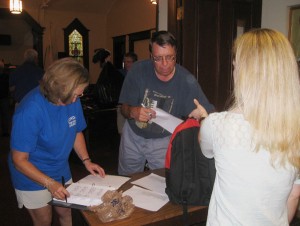 Kathy Kees and Rev. John Zuercher collect the filled back packs